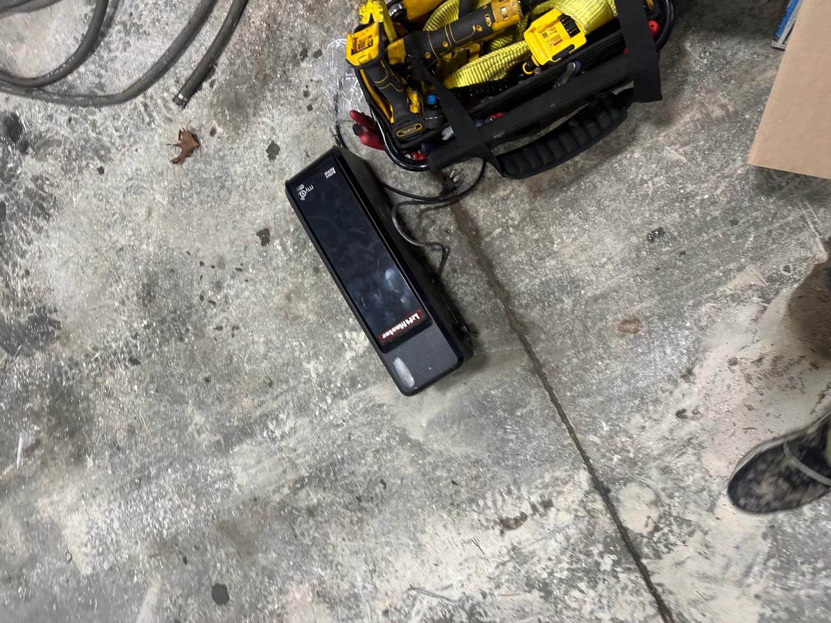 LiftMaster garage door opener staged during service with technician tools — MA